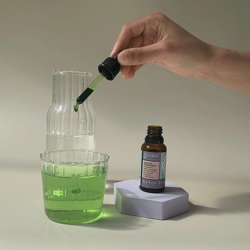 Gif of drops of Detox Drops elixir poured into a glass