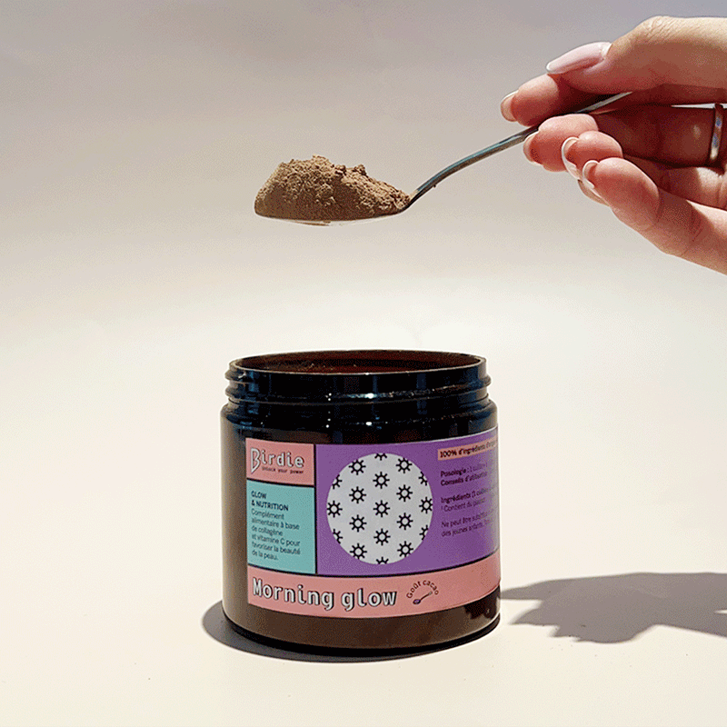Gif of Pouring Morning Glow powder into its jar with a spoon
